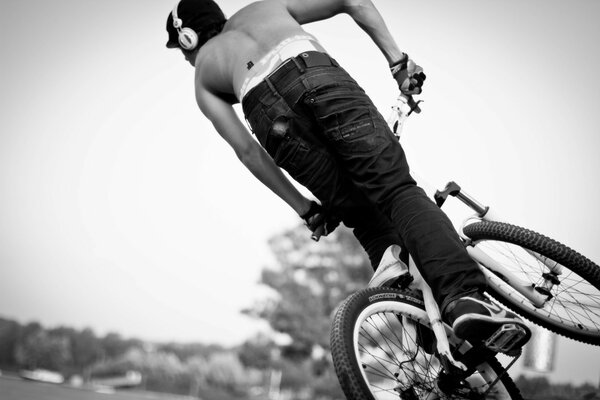 Monochrome photo of a sports stunt on a bicycle