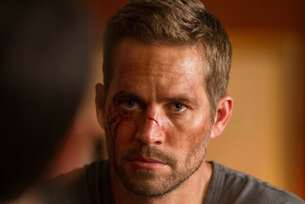 Paul Walker in wounds and abrasions on his face bricks face