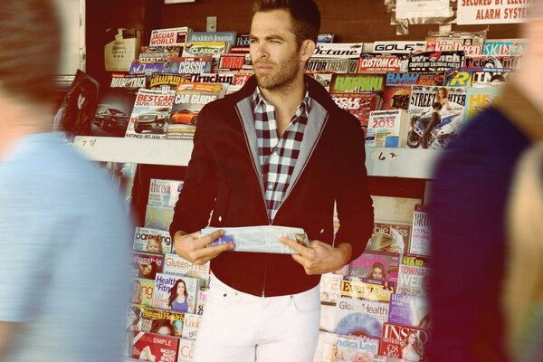 Actor Chris Lyne with a newspaper in his hands