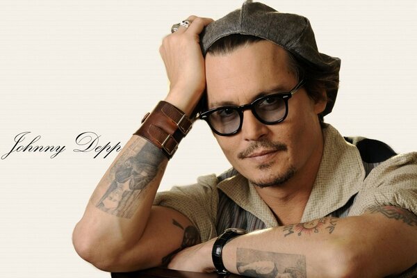 Johnny Depp poses and smiles in the style of a cute glossy cover boy