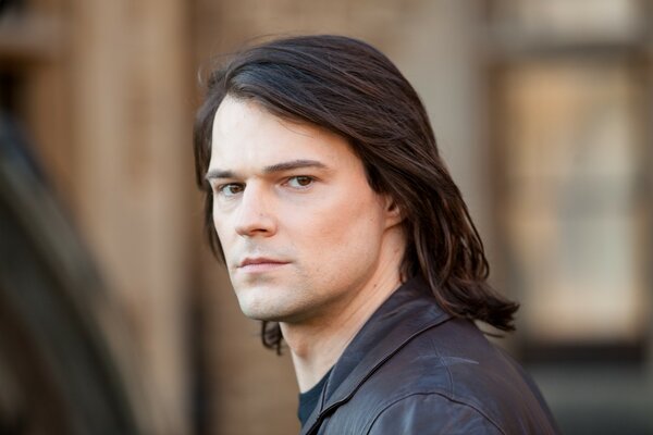 Actor Danila Kozlovsky poses without a mustache and beard, with a square haircut