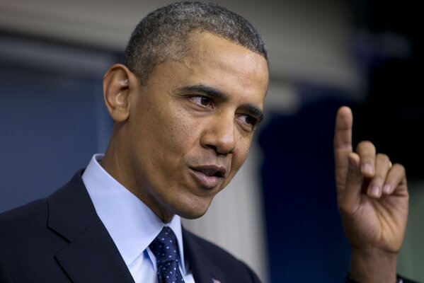 Barack Obama points his finger up