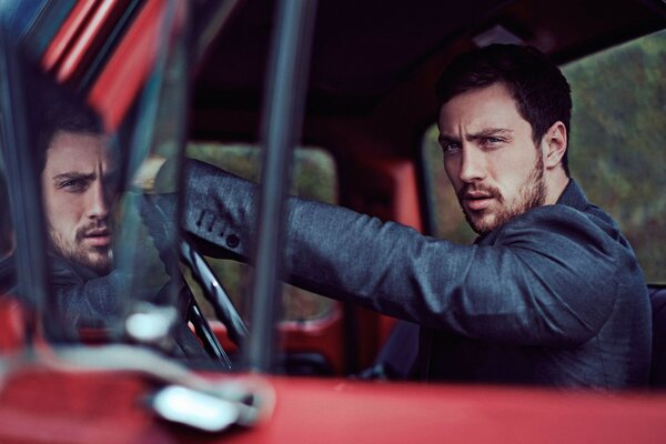 A handsome man driving a car