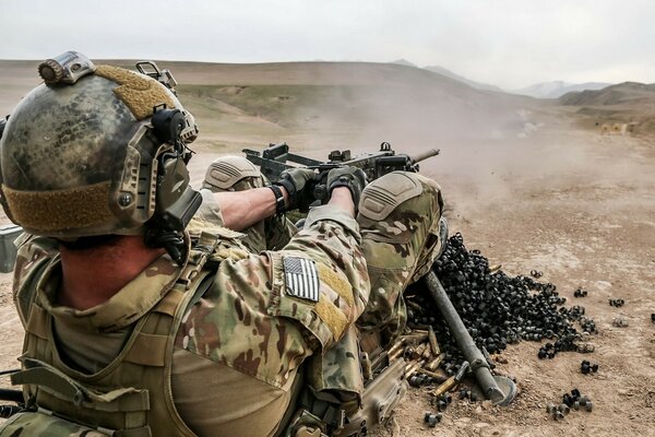 A soldier in Afghanistan fires a machine gun