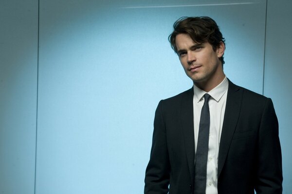 Photo of Matt Bomer on a blue background