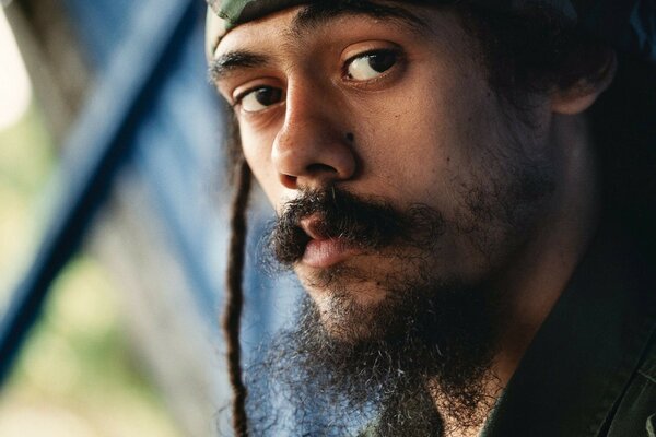 Portrait of a man with dreadlocks and mustache