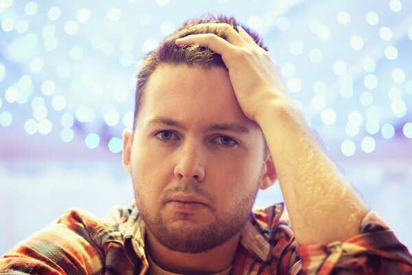 Photo of a man in white light with light stubble and green eyes