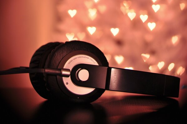 Music in headphones on the background of hearts