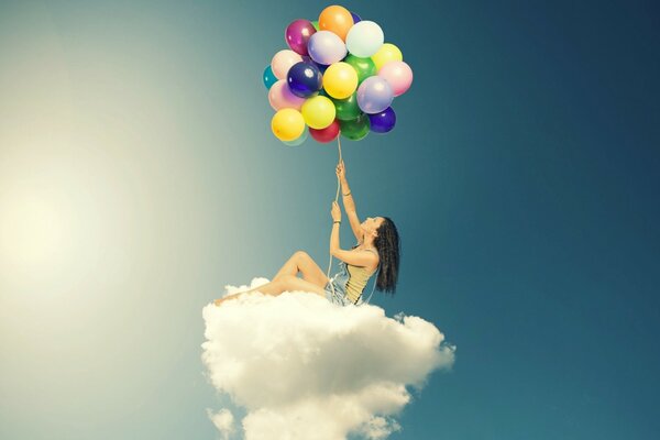 Girl on a cloud with balloons