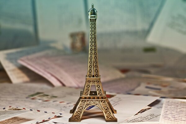 Eiffel Tower statue on a table with letters