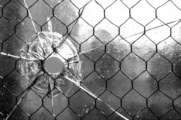 Monochrome photo of a hole in the glass