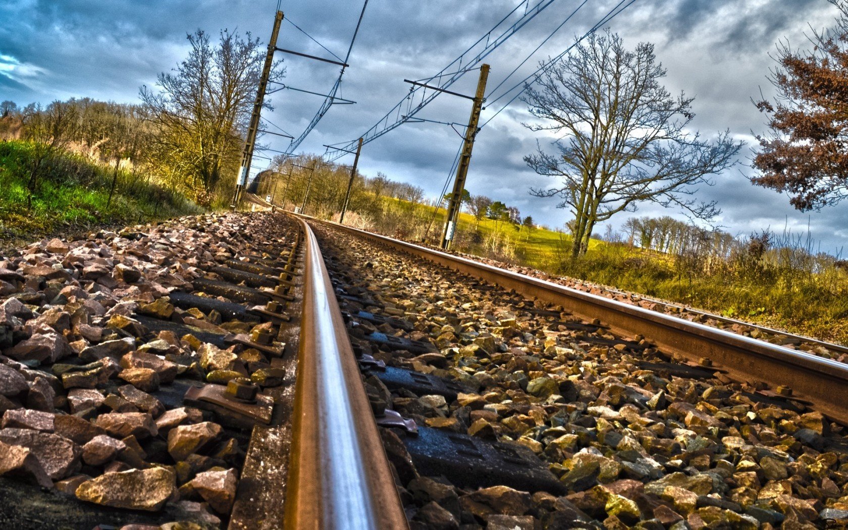 clouds stones railroad rails tree