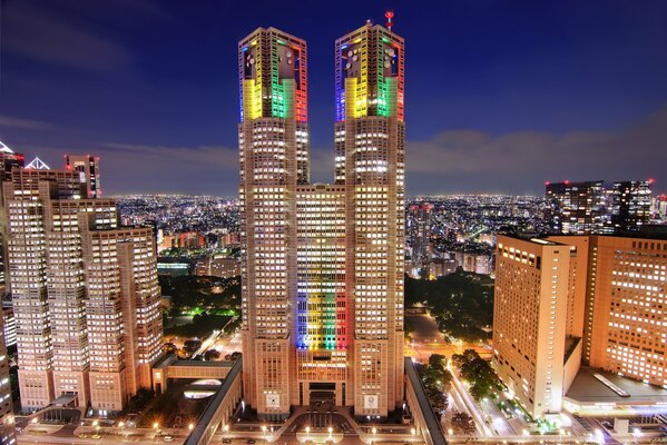 Skyscrapers in different colors on the background of clouds