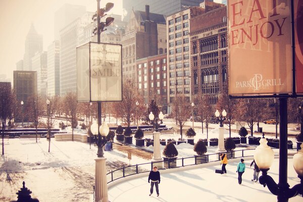 People at the city skating rink among skyscrapers