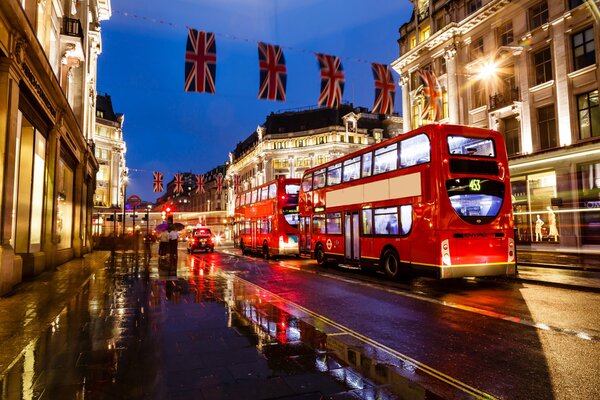 Słynne Londyńskie autobusy na wieczornej ulicy