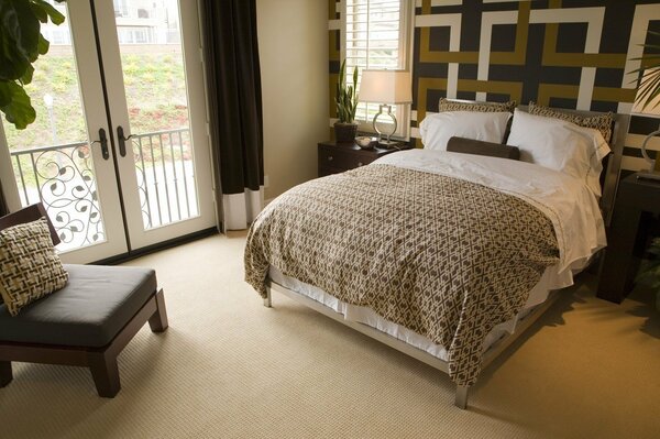 Stylish bedroom with an abstract pattern above the headboard