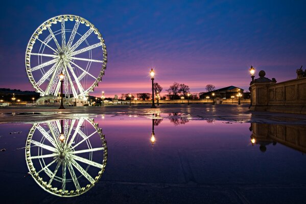Ferris wheel at night in France. Early