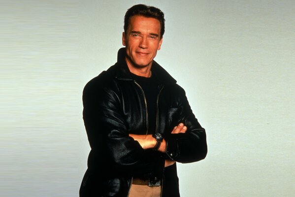 A cheerful Schwarzenegger poses on a white background