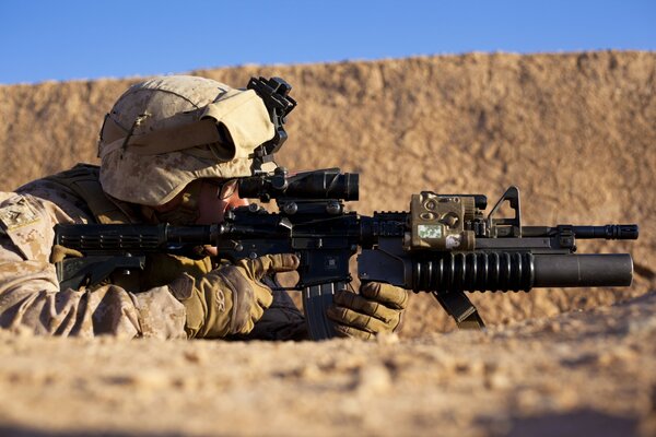 A soldier with a weapon at a combat post