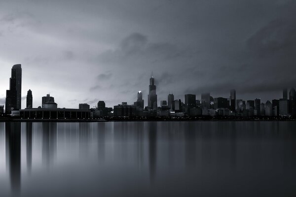 Gloomy skyscrapers in the fog over the water