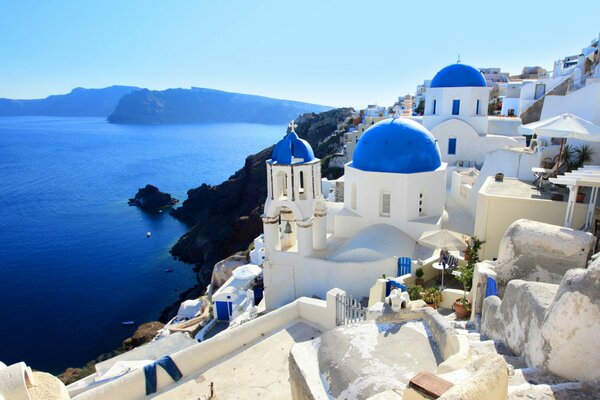 Santorin mit weißen Häusern mit blauen Dächern am Meer