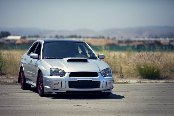 A tuned Subaru on a beautiful background