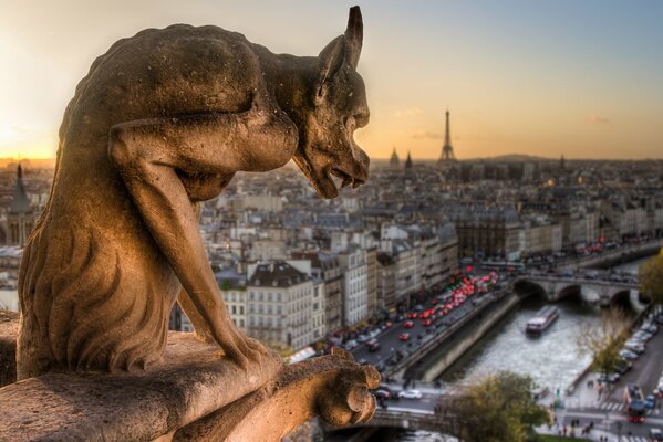 Chimeras hiding at the foot of the upper towers of the Paris Cathedral