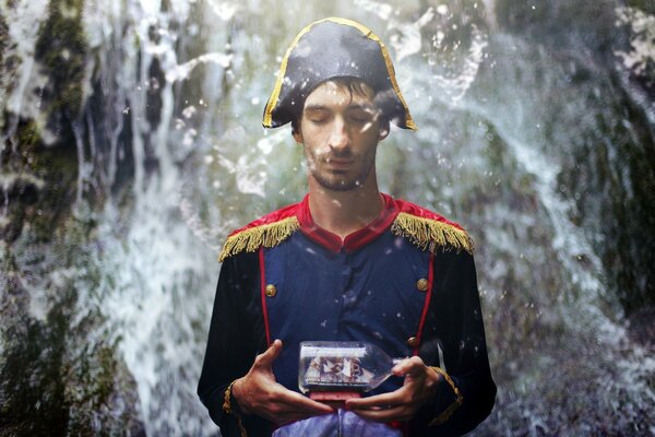 Captain of a ship with a miniature boat on the background of water