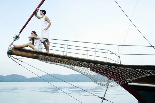 A guy and a girl on a yacht at sea