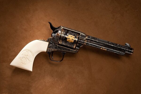 A pistol with a white handle on a brown background