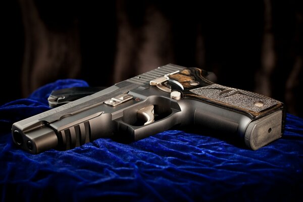 Sig sauer weapons on blue fabric