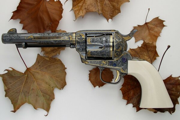 Painted revolver with a white handle and glue leaves