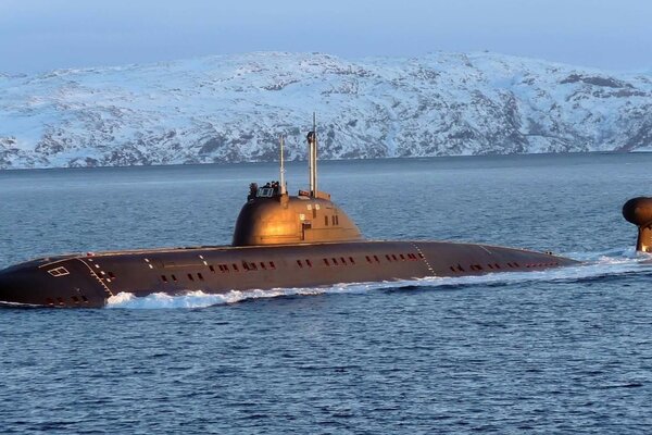 Submarine on the background of hilly snow-capped mountains