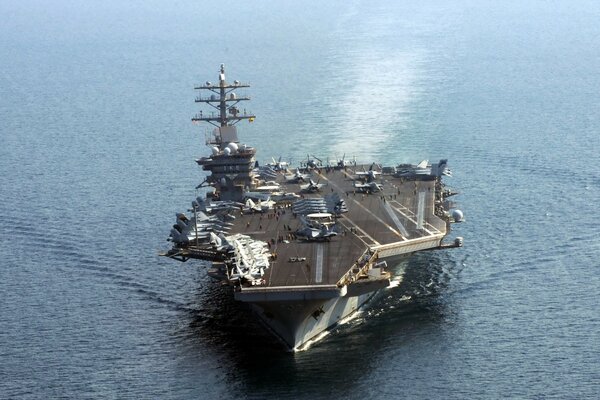 An aircraft carrier with weapons in the middle of the ocean