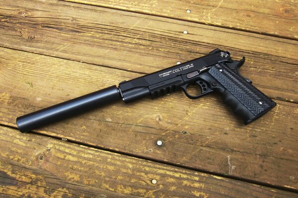 A pistol with a silencer on the board