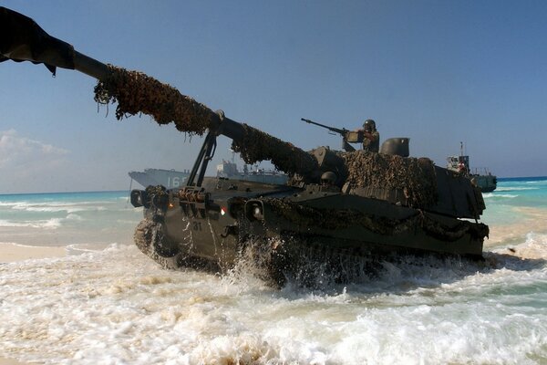 Tank on the background of blue sea and yellow sand