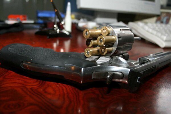 A military revolver with bullets on the table