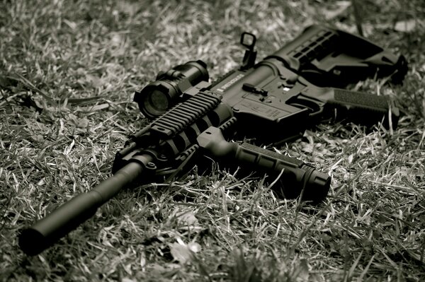 Black and white photo of a rifle on the grass