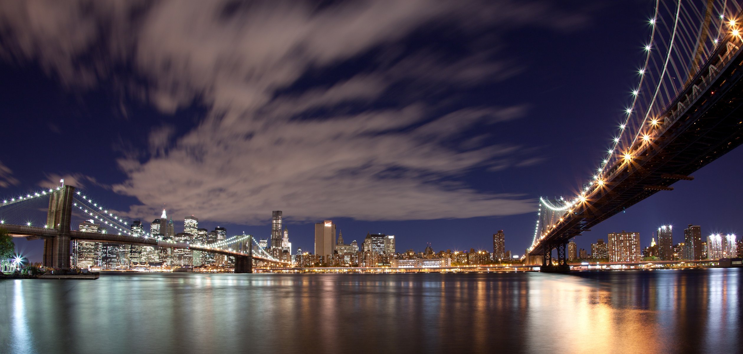 usa new york city brooklyn bridge evening lights sky clouds panorama