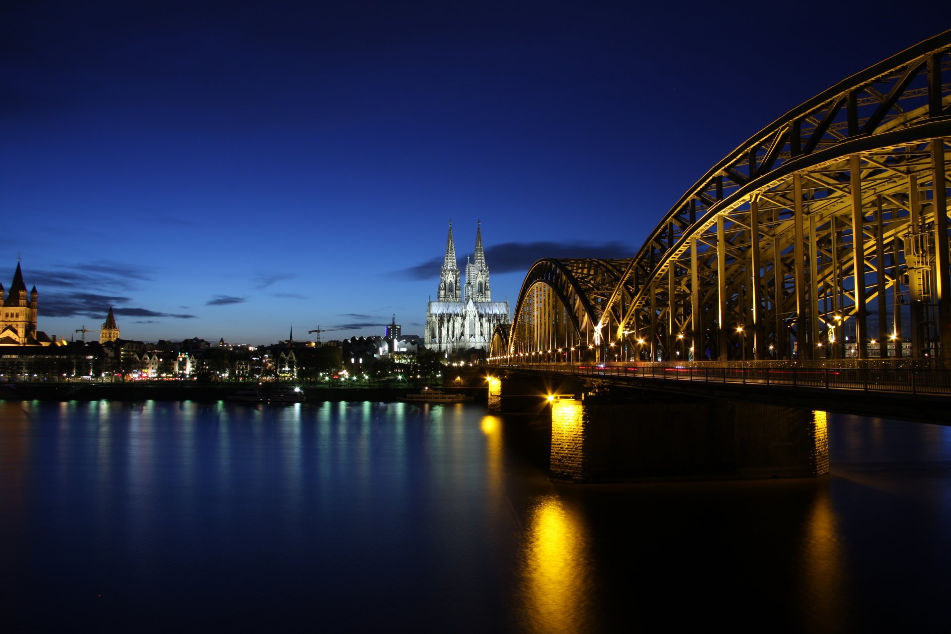 germany cologne cologne evening buildings architecture illumination bridge river rhine reflection