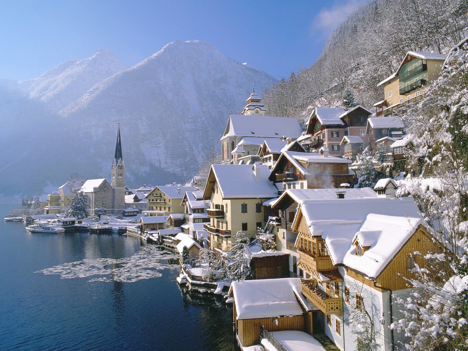 hallstatt österreich leinwand stadt land winter häuser berge wasser eis holz äste schnee