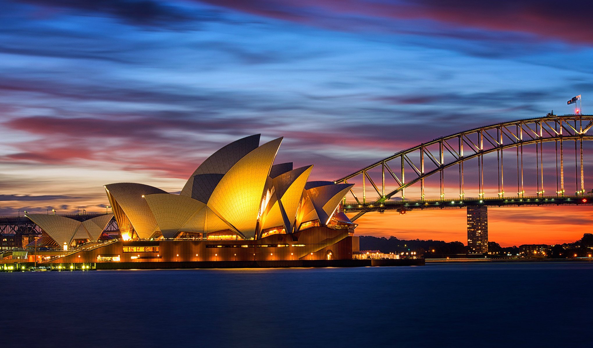 australia sydney opera house bridge night lights lighting orange sunset sky clouds gulf sea