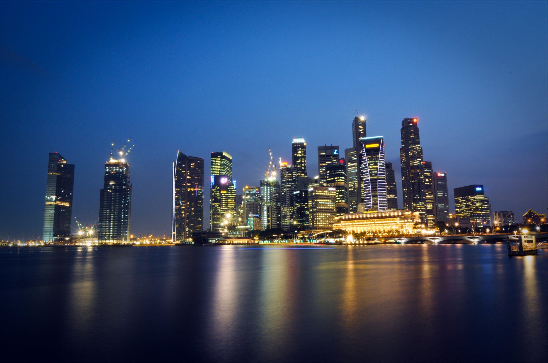 malaysia singapore city state metropolis skyscraper night lights light blue sky strait reflection