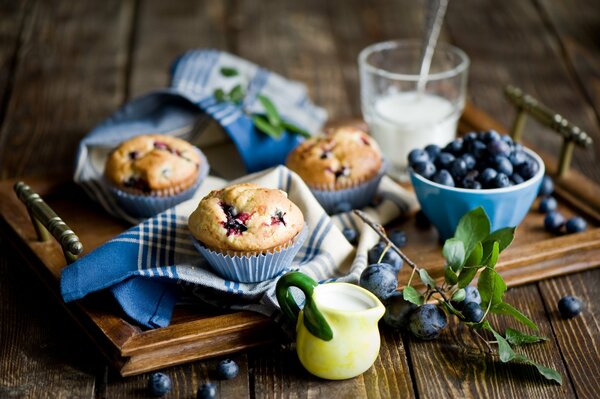 Cupcakes on a tray with berries and napkins