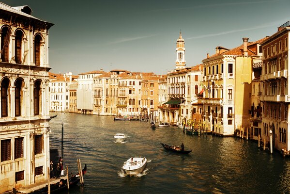 The fascinating architecture of Venice with a canal through which gondolas float