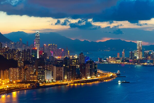 Illuminated embankment at dusk in Hong Kong