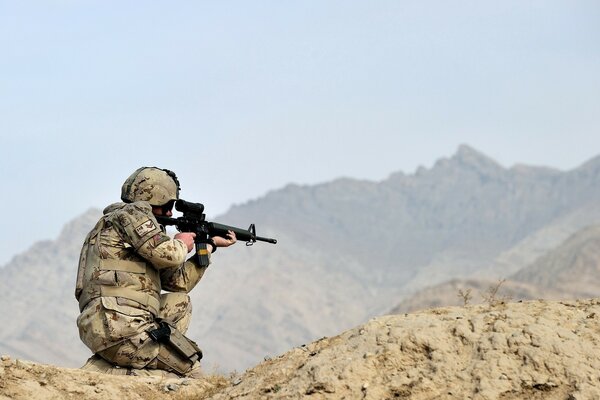 Фото солдата с оружием в горах