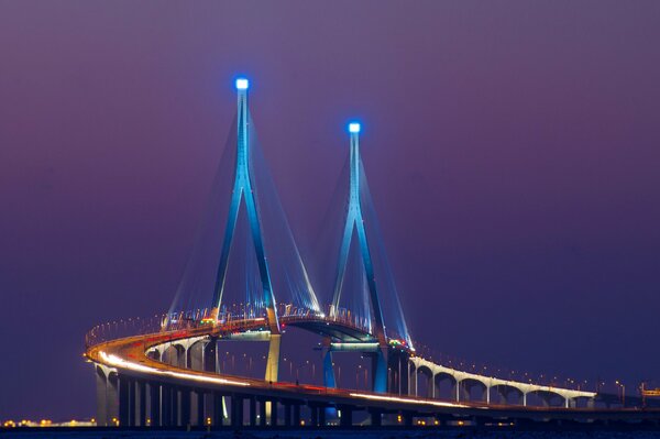 At night, the bridge lights up with colorful lights