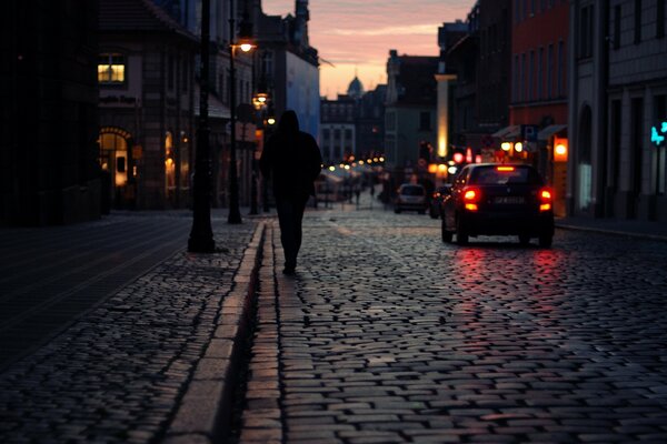 Night city street. Lights of houses and cars