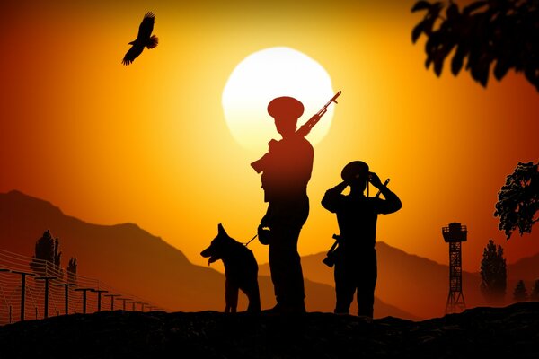 Silhouettes of border guards at sunset